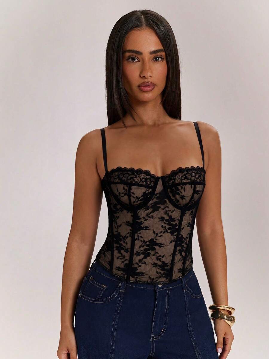 Black women’s lace cami top with spaghetti straps, contrast lace details, and an asymmetrical hem, styled as a slim-fit lined casual top.