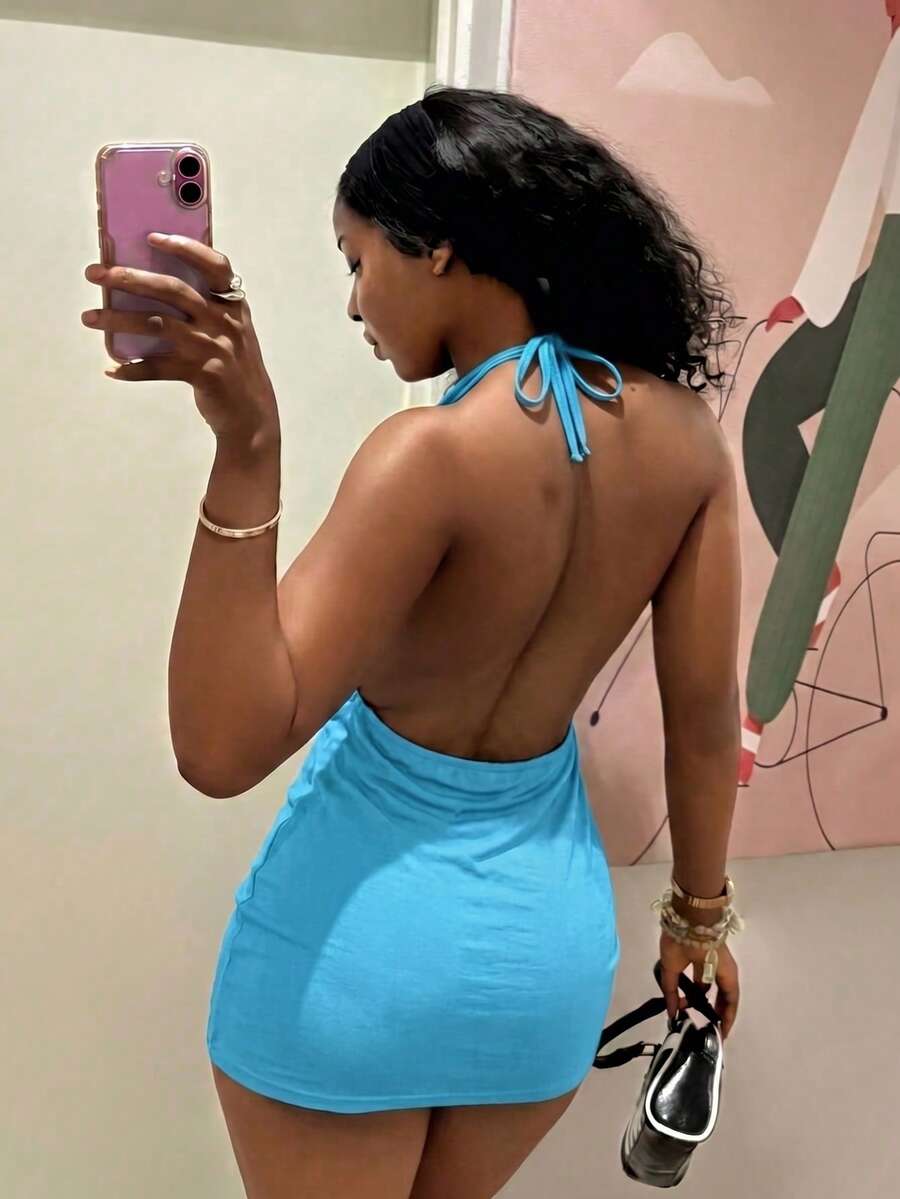 Women's black deep V-neck halter bodycon mini dress featuring a backless design with chain decor detail.