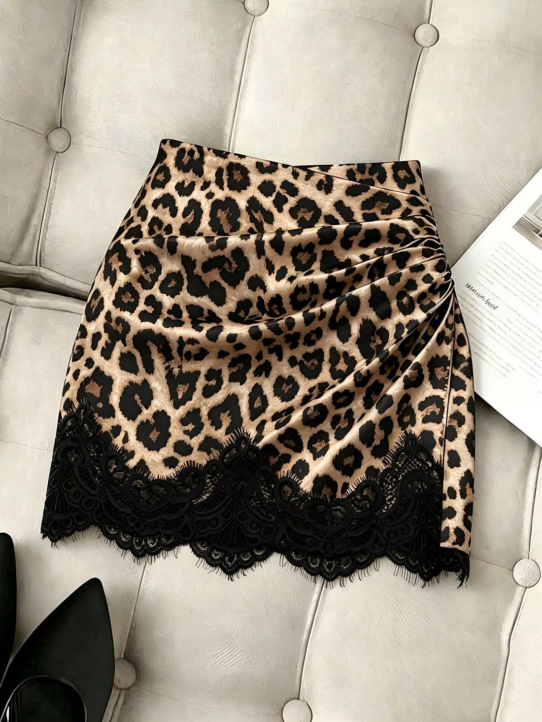 Women's brown leopard print bodycon mini skirt featuring black contrast lace trim around the hemline.