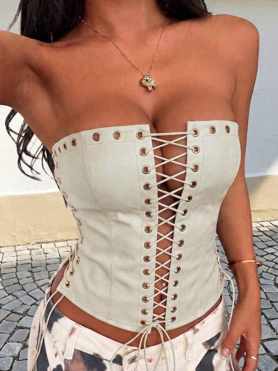 Women’s coffee brown faux leather lace-up crop top with strapless neckline, slit hem, and slim fitted silhouette for festival and nightlife wear.