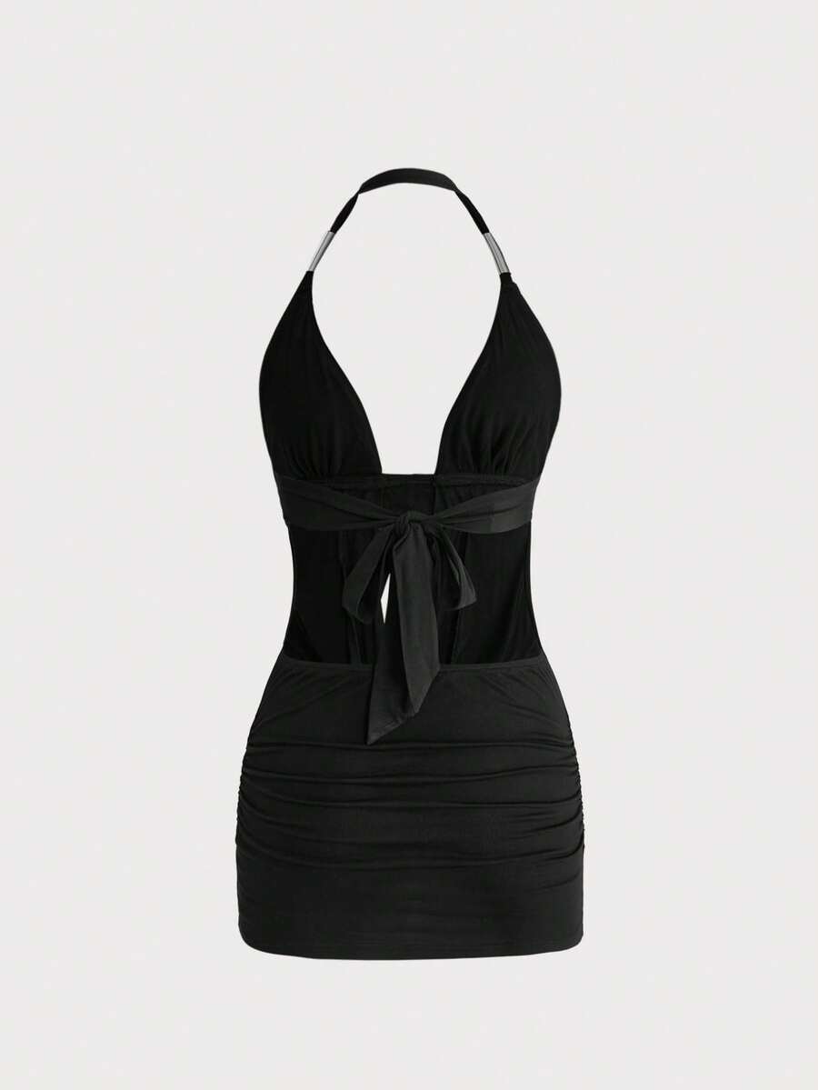 Sleeveless halter backless mini bodycon dress with high waist and tie-back detailing.