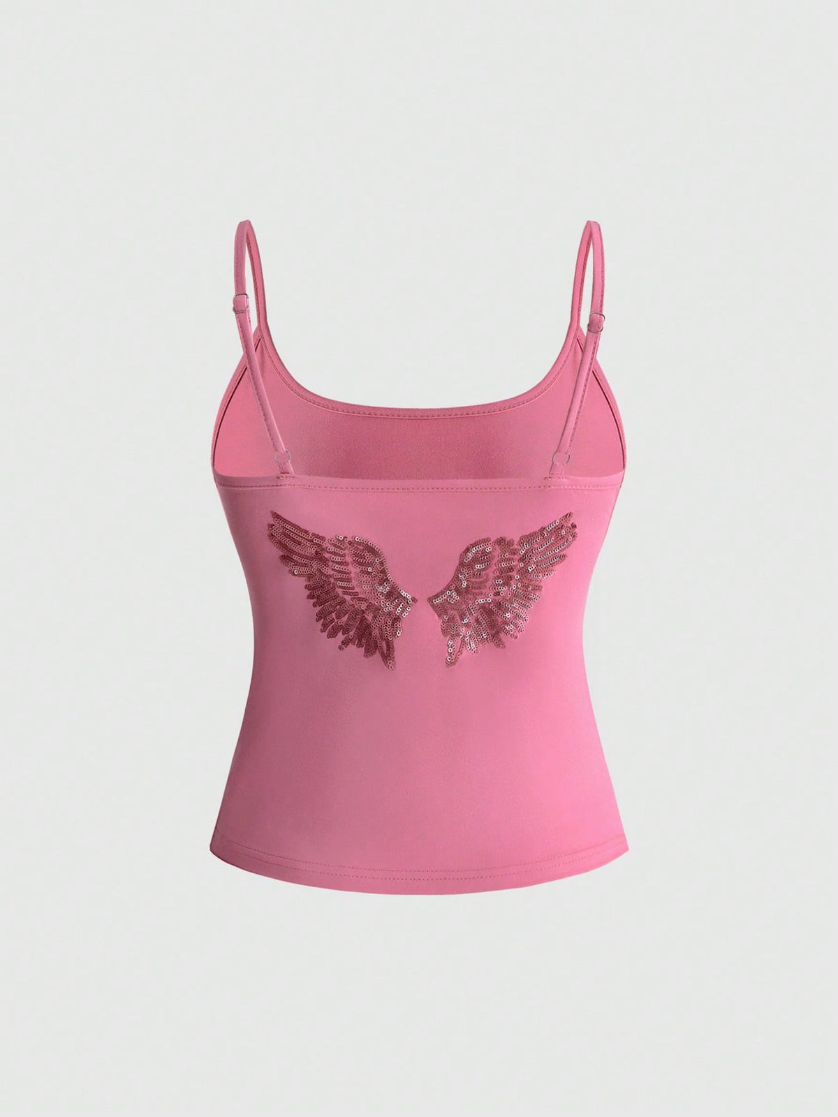 Women's pink cropped spaghetti strap tank top featuring a rhinestone wing design on the back in a slim fit knit style.