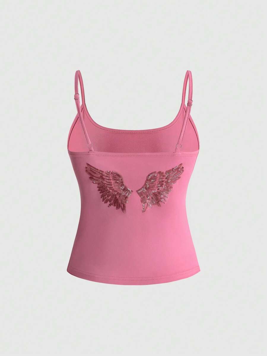 Women's pink cropped spaghetti strap tank top featuring a rhinestone wing design on the back in a slim fit knit style.