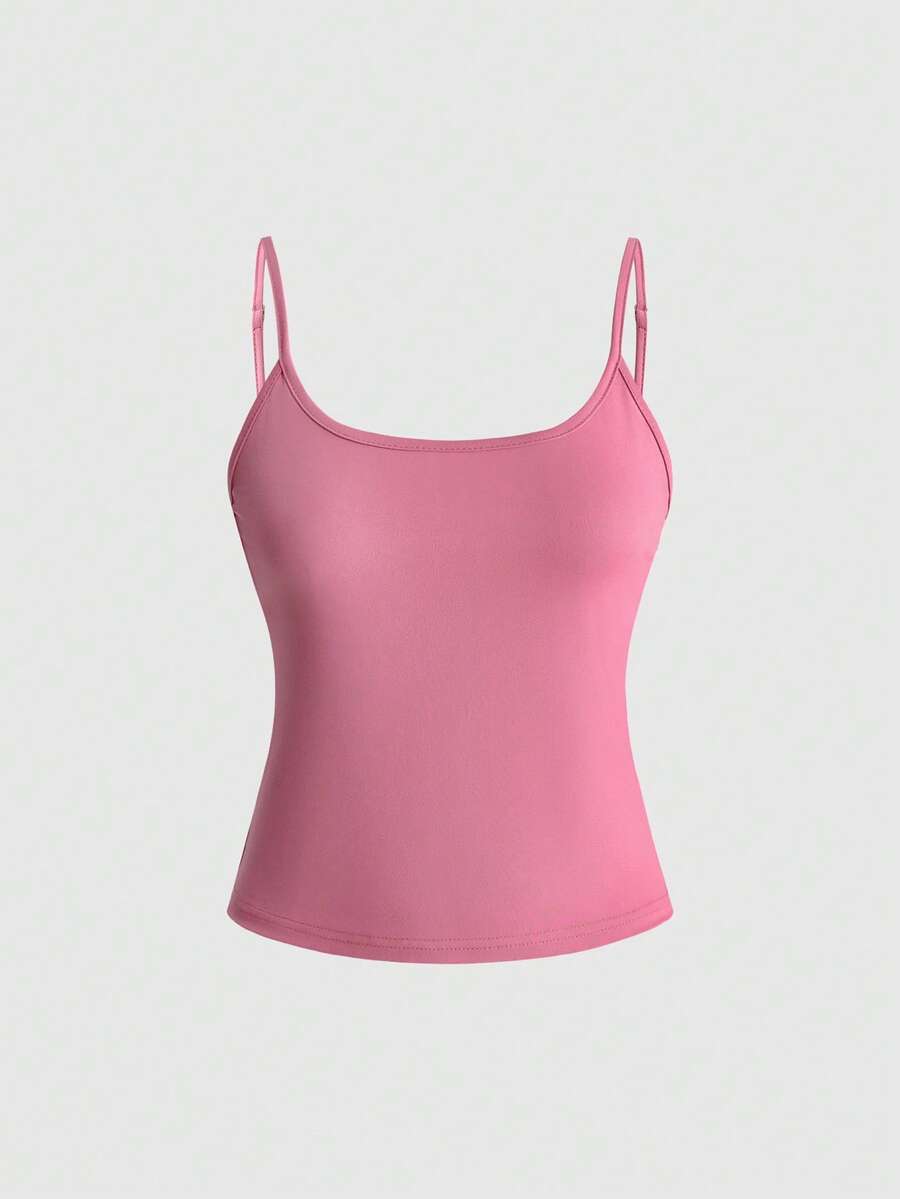 Women's pink cropped spaghetti strap tank top featuring a rhinestone wing design on the back in a slim fit knit style.