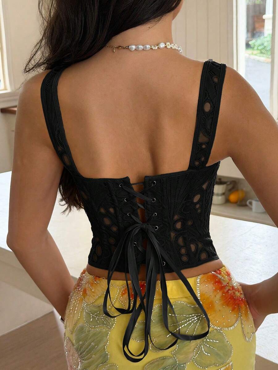 White slim fit boned corset top featuring a square neckline, wide straps, lace-up back, and asymmetrical hem.