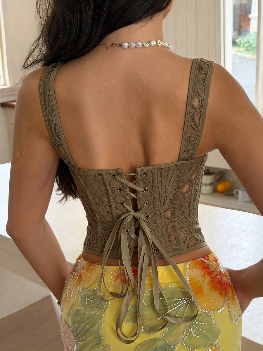 White slim fit boned corset top featuring a square neckline, wide straps, lace-up back, and asymmetrical hem.