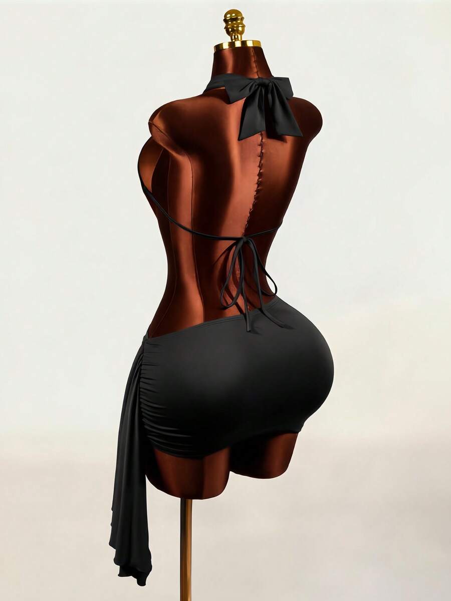 Women's black halter hollow out mini bodycon dress featuring backless asymmetrical knot details and a slim pencil fit.