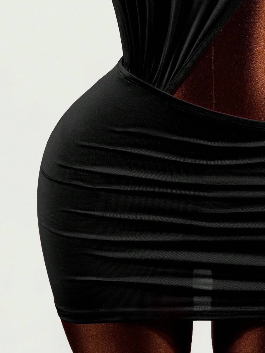 Women's black halter hollow out mini bodycon dress featuring backless asymmetrical knot details and a slim pencil fit.
