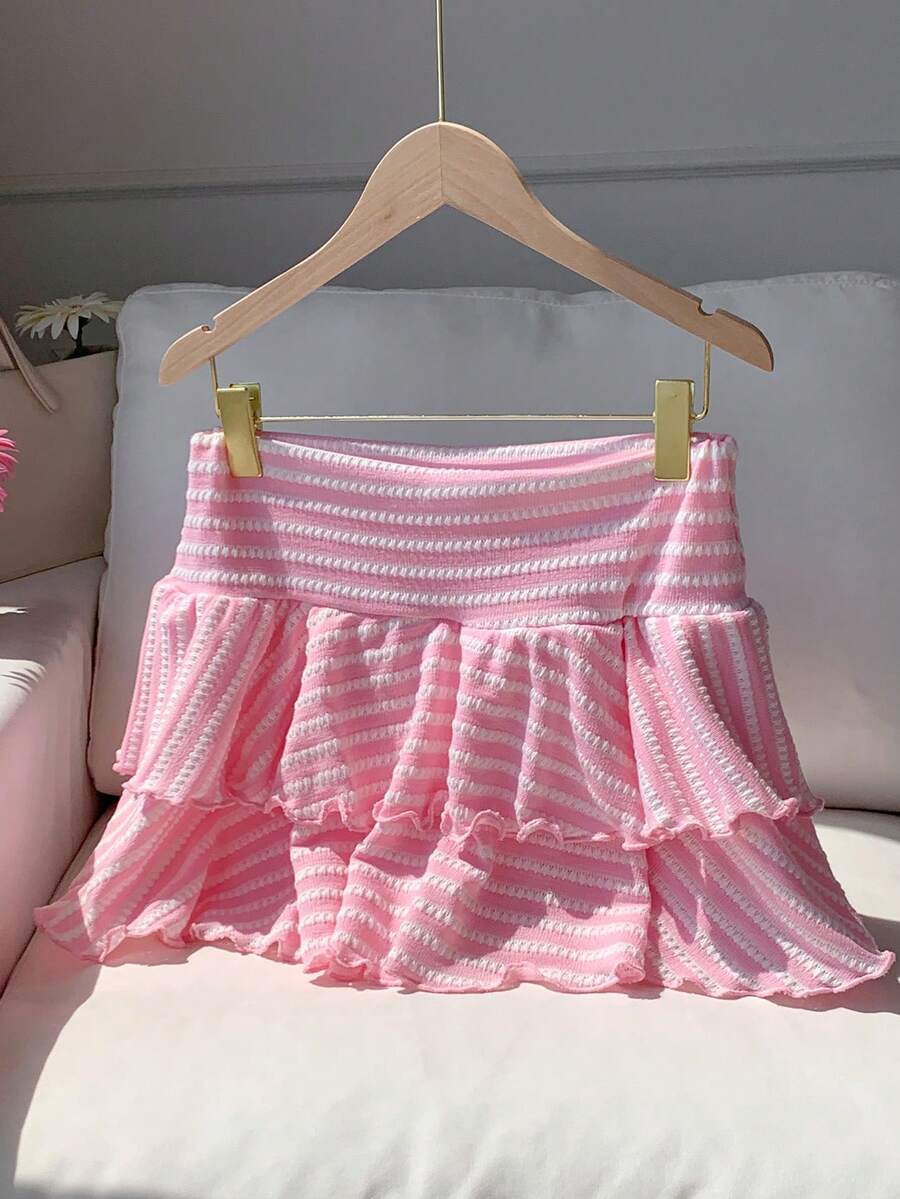 Black low waist knit mini skirt featuring a tiered ruffle hem and skinny high stretch fit.