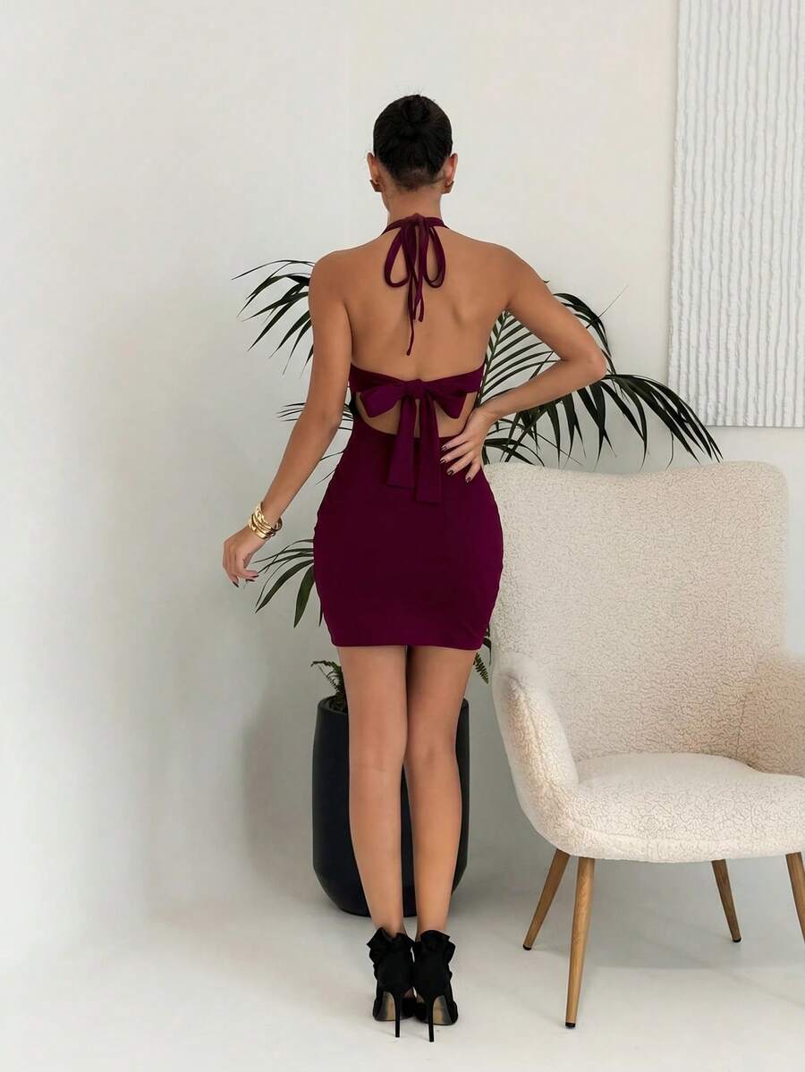 Sleeveless women's halter backless bodycon mini dress featuring lace-up knot back details and a high-waist pencil hem.