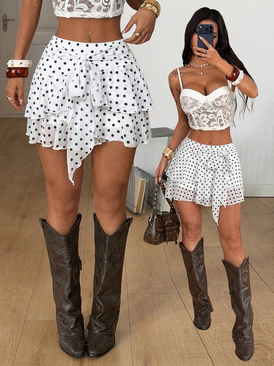 Black low waist tiered mini skirt featuring a ruffle hem and ring accent detail on knitted stretch fabric for women.
