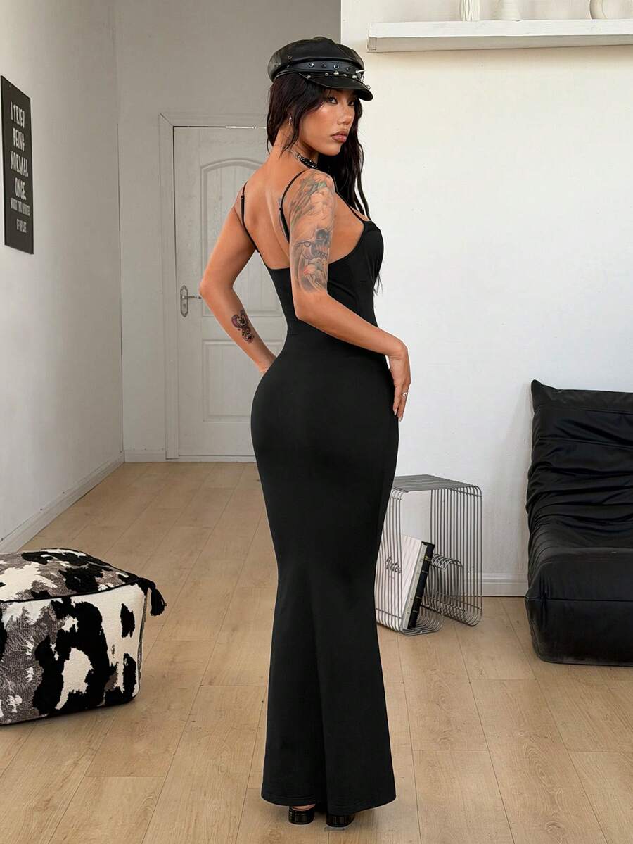 Black backless cami midi dress for women featuring spaghetti straps, slim fit mermaid silhouette, backless button detail, and high stretch knitted fabric.