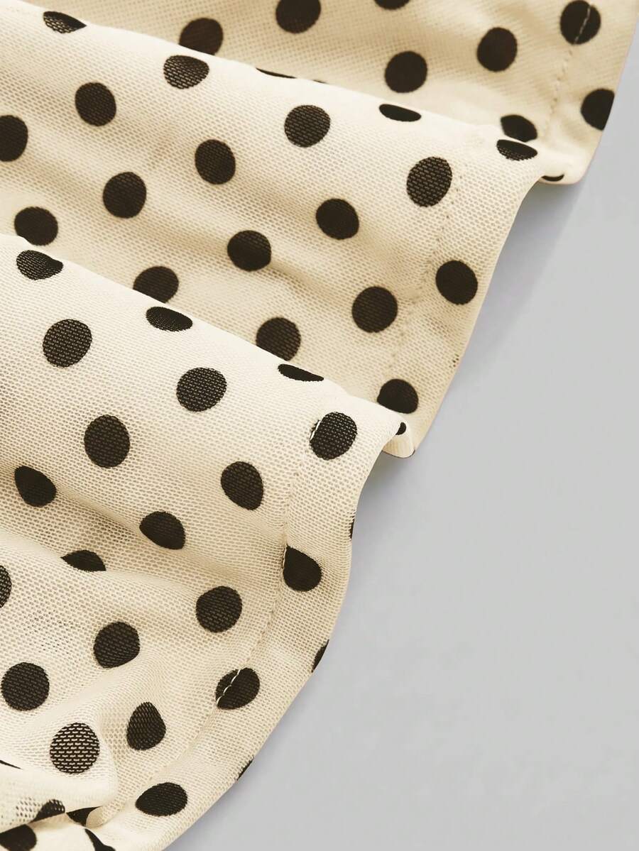 Women's black polka dot strapless tube top made of ruched mesh fabric featuring an asymmetrical hem and matching scarf.