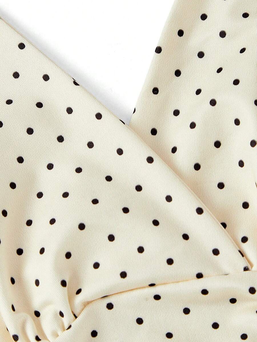 Women's halter crop tank top featuring a backless silhouette and ruched detailing in a slim fit design.