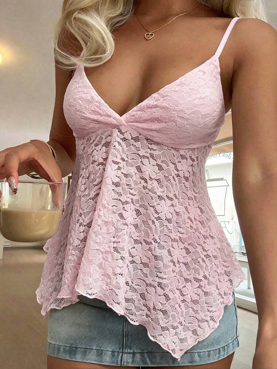 Women's white deep V-neck lace cami top featuring thin straps, semi-sheer lace fabric, and an asymmetrical hemline.