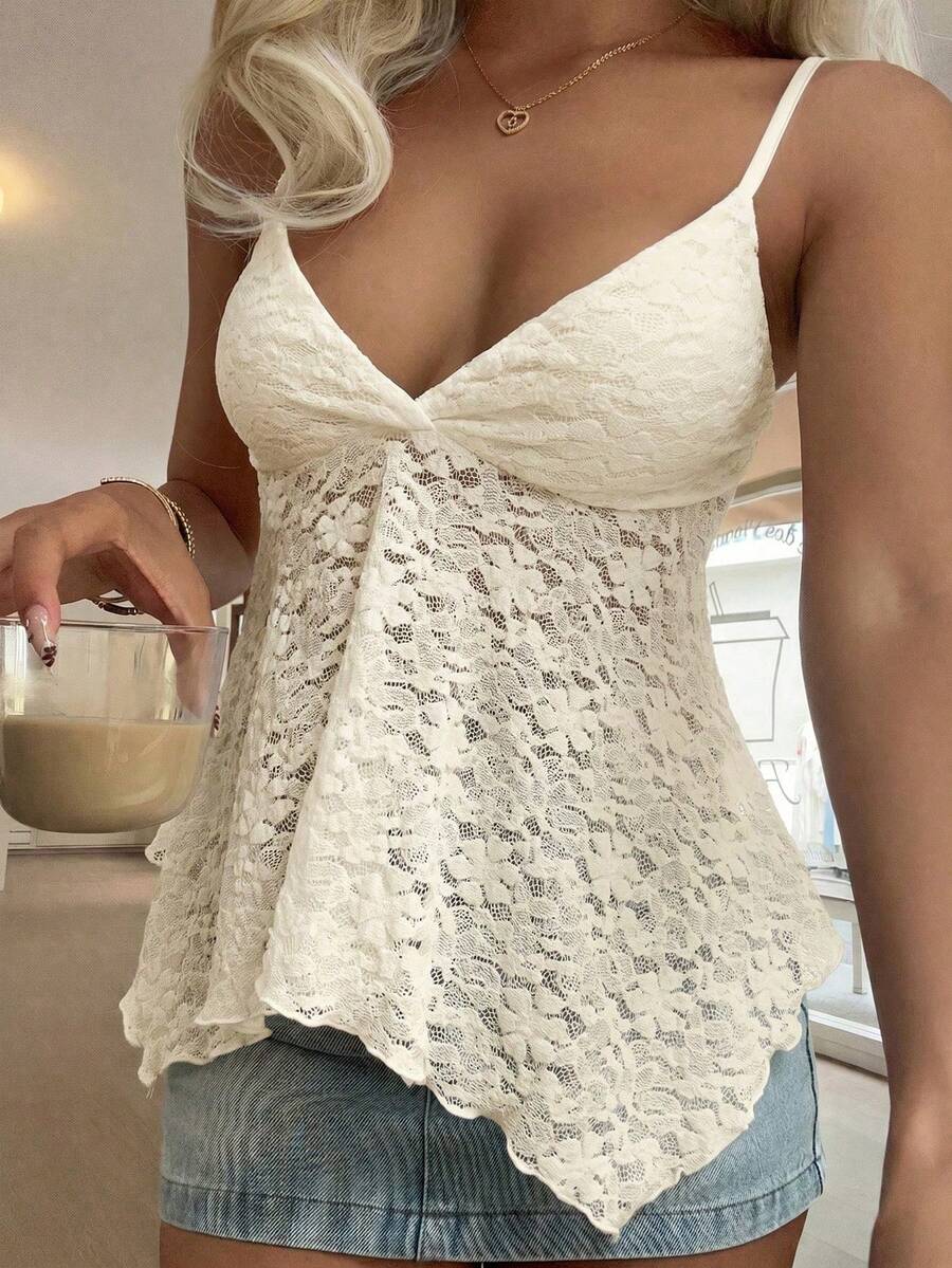 Women's white deep V-neck lace cami top featuring thin straps, semi-sheer lace fabric, and an asymmetrical hemline.