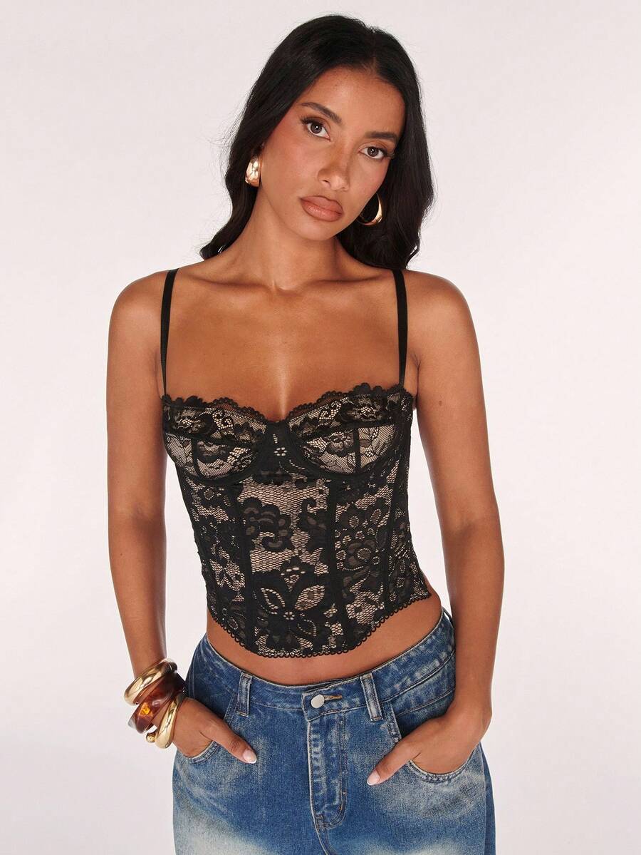 Black women’s lace cami top with spaghetti straps, contrast lace details, and an asymmetrical hem, styled as a slim-fit lined casual top.