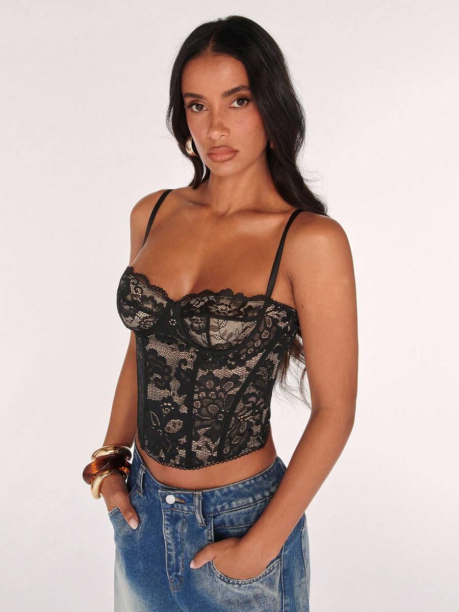 Black women’s lace cami top with spaghetti straps, contrast lace details, and an asymmetrical hem, styled as a slim-fit lined casual top.