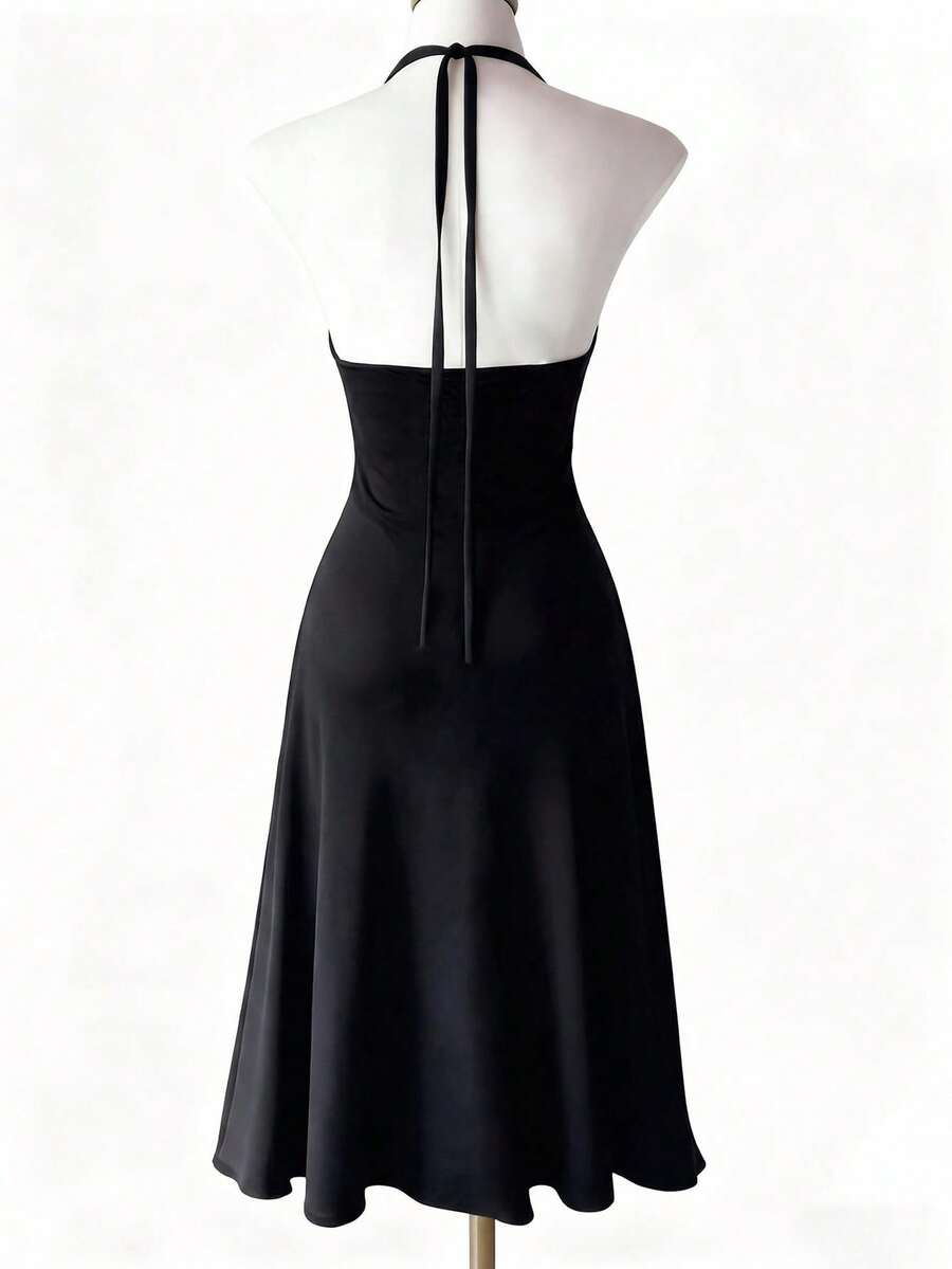 Black knitted sleeveless halter dress featuring cut out detailing, high waist, and side slit hem.