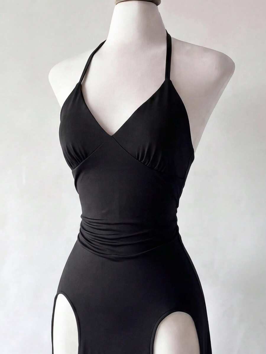 Black knitted sleeveless halter dress featuring cut out detailing, high waist, and side slit hem.