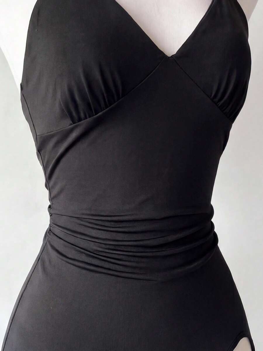 Black knitted sleeveless halter dress featuring cut out detailing, high waist, and side slit hem.