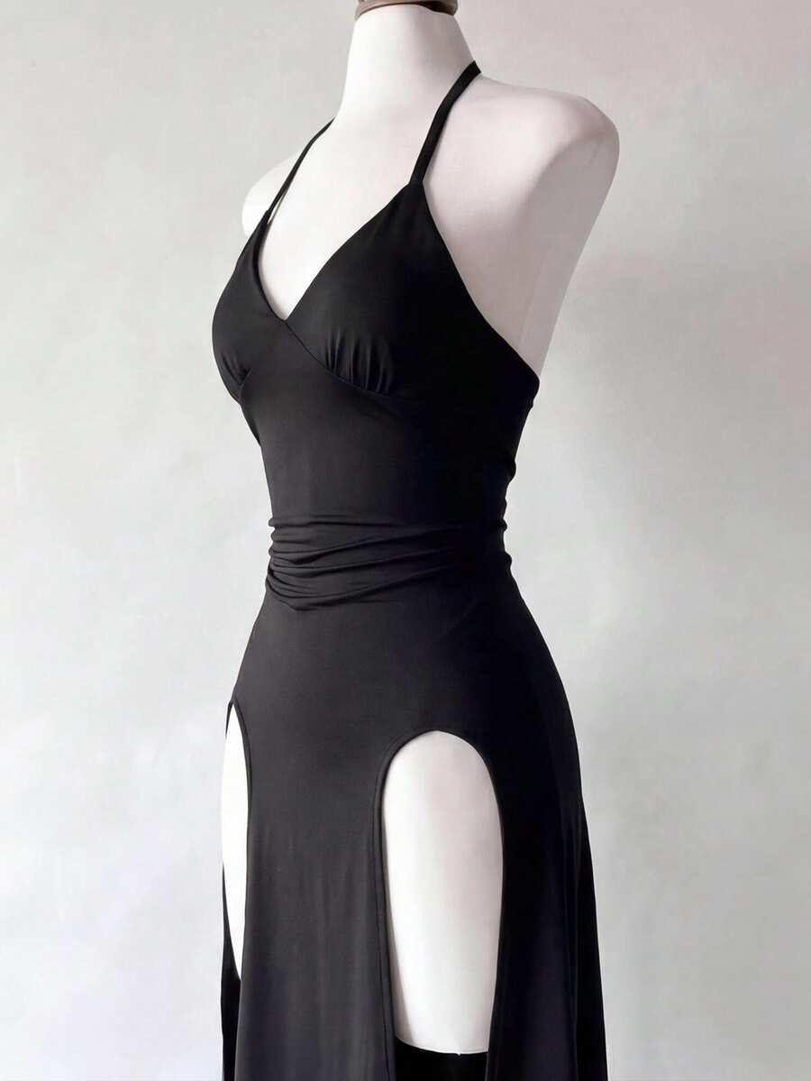 Black knitted sleeveless halter dress featuring cut out detailing, high waist, and side slit hem.