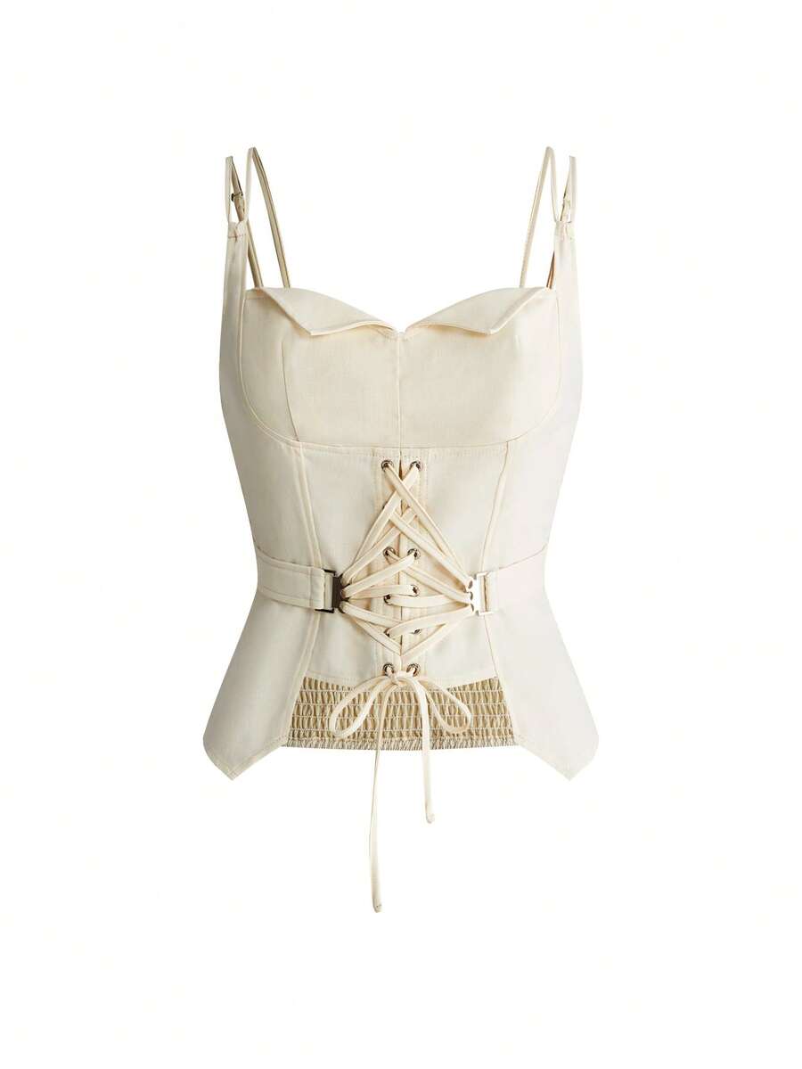 White lace-up crop camisole top for women featuring grommet eyelet details, a sweetheart neckline, shirred back, and asymmetrical hem.