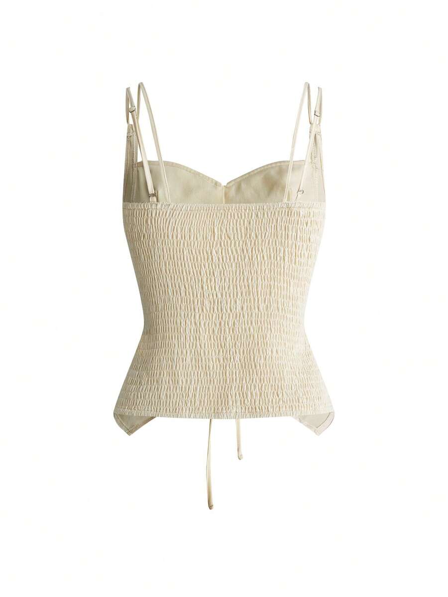 White lace-up crop camisole top for women featuring grommet eyelet details, a sweetheart neckline, shirred back, and asymmetrical hem.