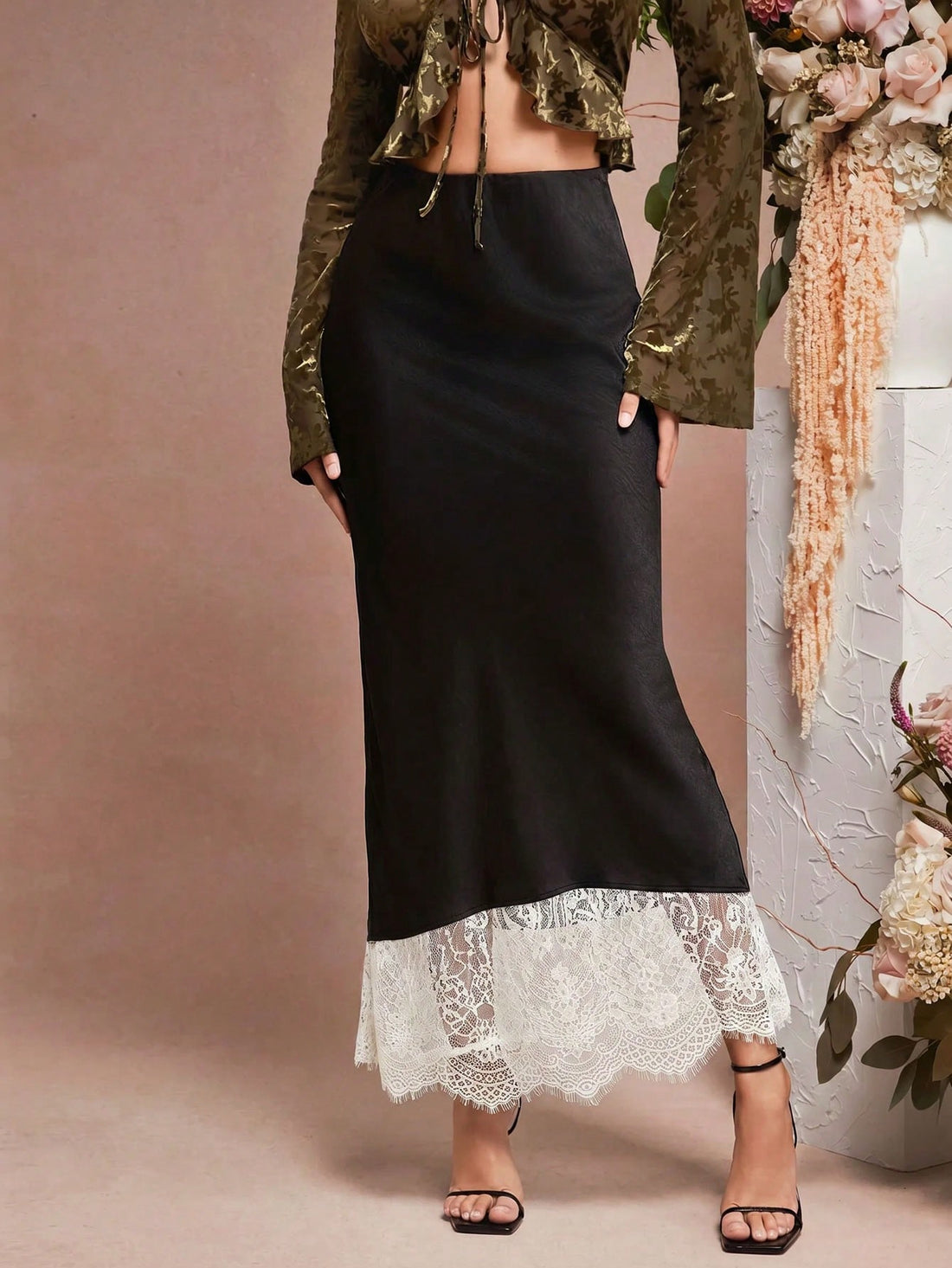 Women's black lace patchwork satin midi skirt featuring a mid-waist mermaid silhouette and scallop contrast lace trim.