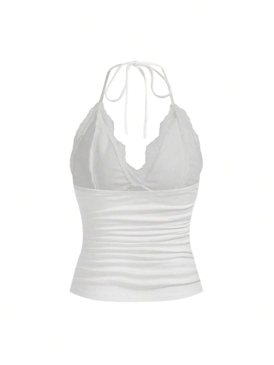A women's black backless halter top featuring contrast lace trim, ruched front detail, and slim fit soft knitted fabric.