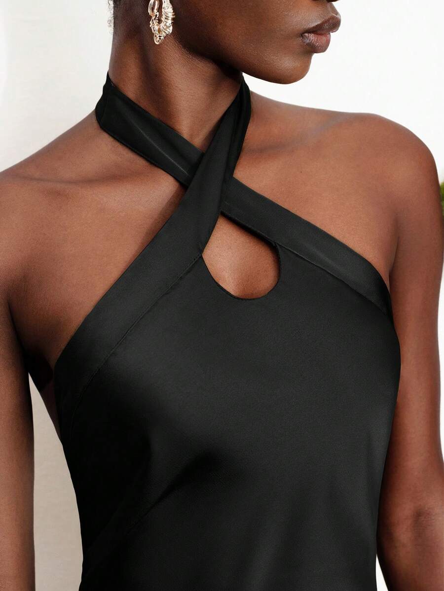 Women's black satin halter neck bodycon midi dress featuring a sleeveless backless design with front slit hem and wrap details.