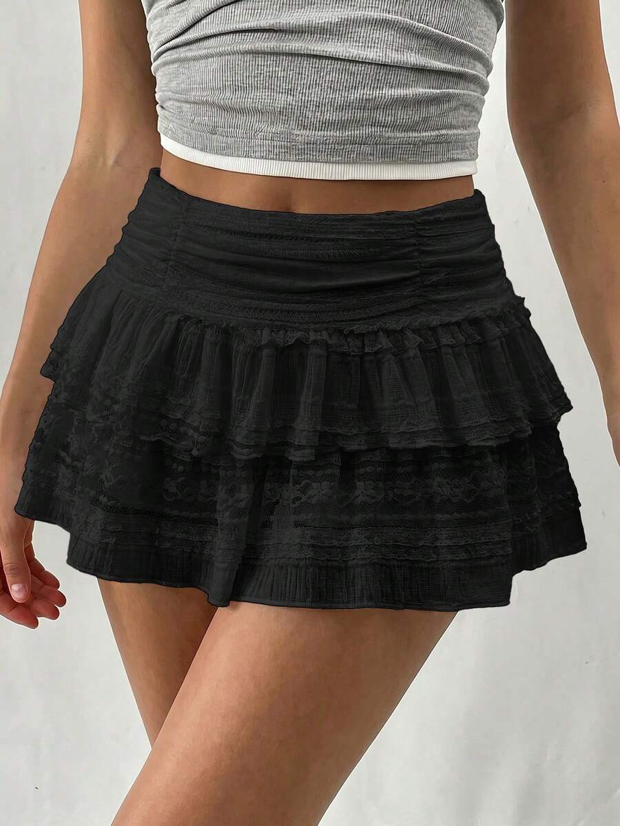 Women's black tiered lace mini skort featuring a double-layered contrast ruffle hem, lined interior, and mid-waist fit.