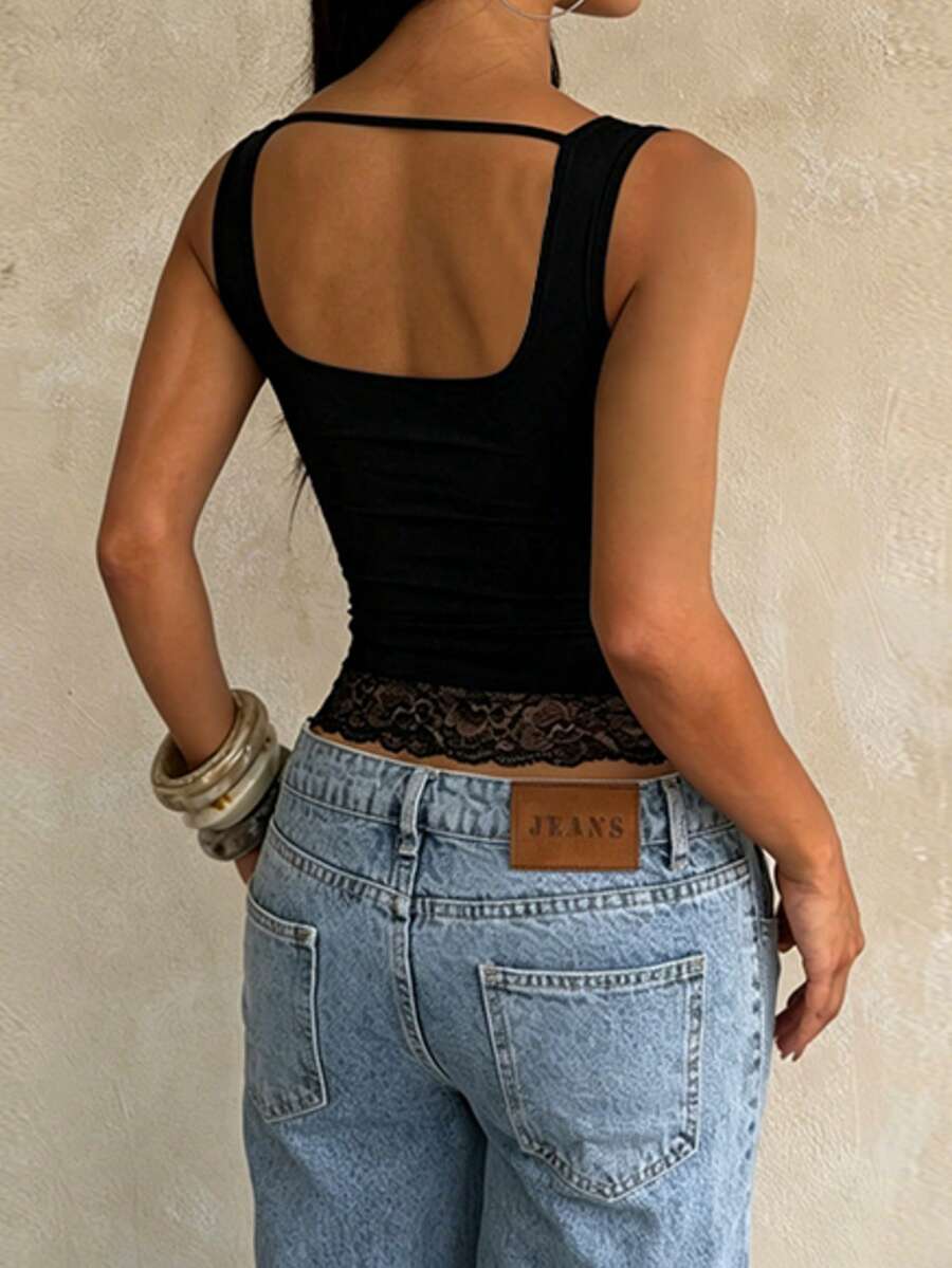 Women's white sleeveless crop top with contrast lace trim, shoulder straps, and a floral graphic print.