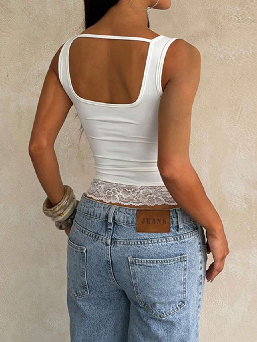 Women's white sleeveless crop top with contrast lace trim, shoulder straps, and a floral graphic print.