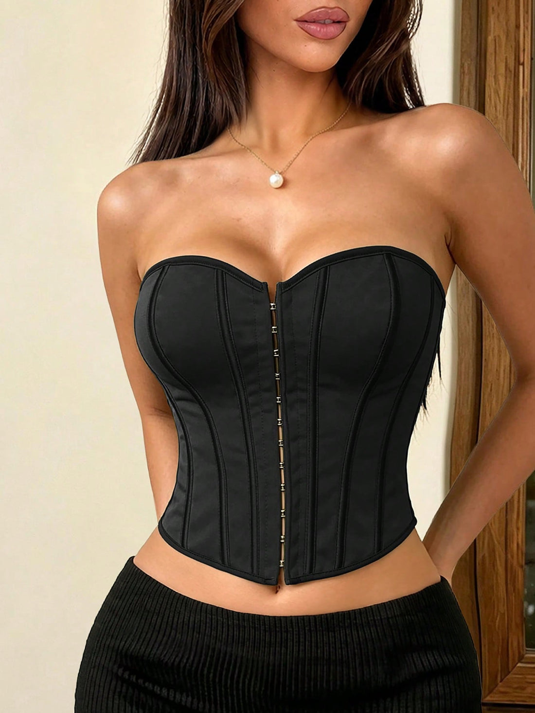 Women's black backless lace-up bustier tube top featuring asymmetrical hem and grommet eyelet details.