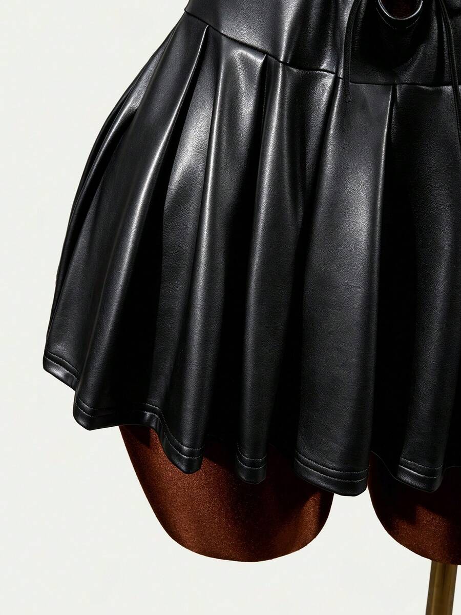 Black halter mini dress with cold shoulder design, contrast mesh detail, and flared A-line hem.