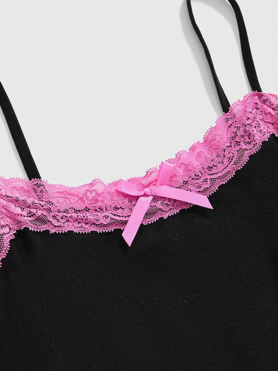 Black women's micro crop cami top featuring graphic crown print, contrast lace trim, bow detail, and spaghetti straps.