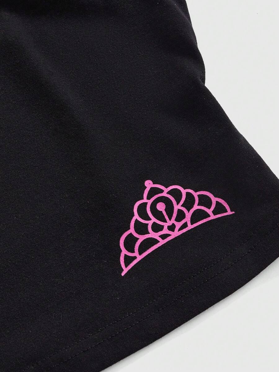 Black women's micro crop cami top featuring graphic crown print, contrast lace trim, bow detail, and spaghetti straps.