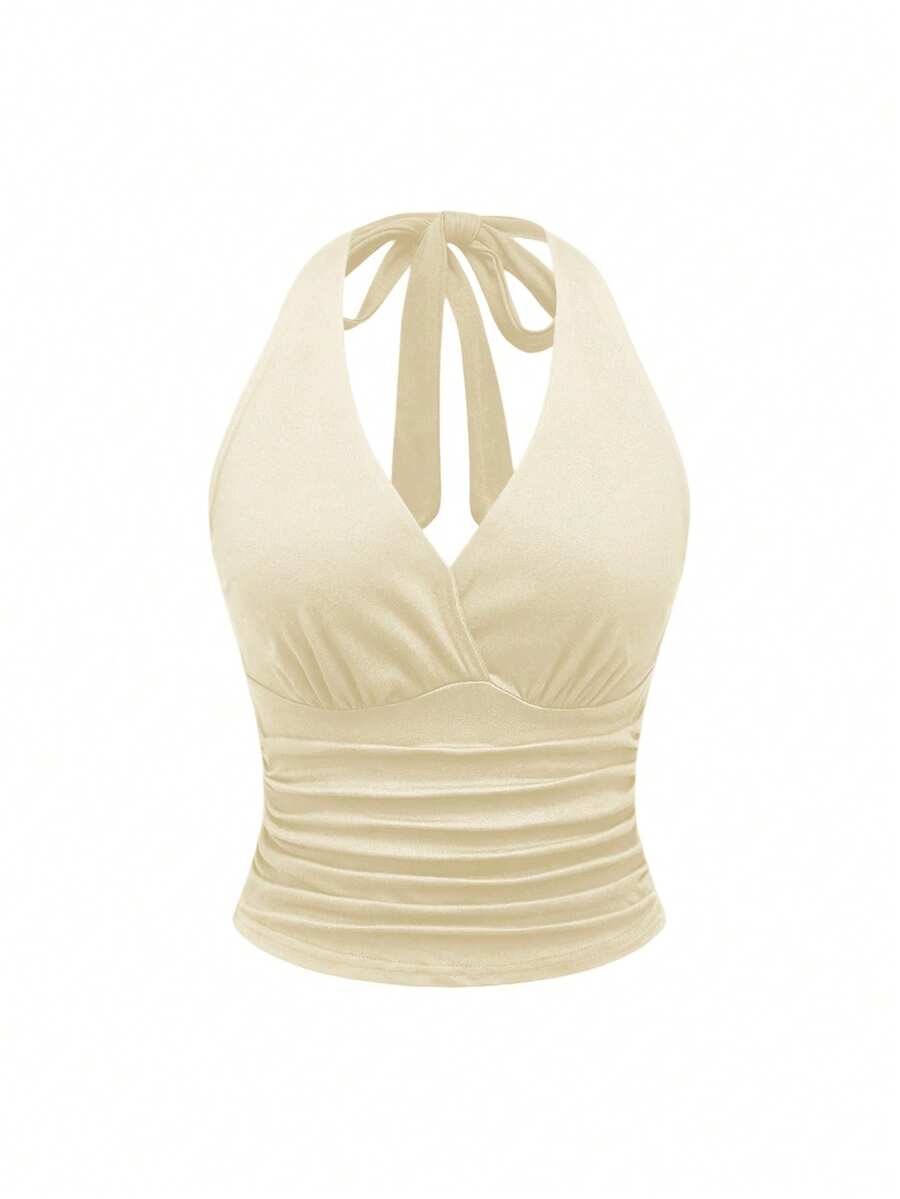 Women's halter crop tank top featuring a backless silhouette and ruched detailing in a slim fit design.