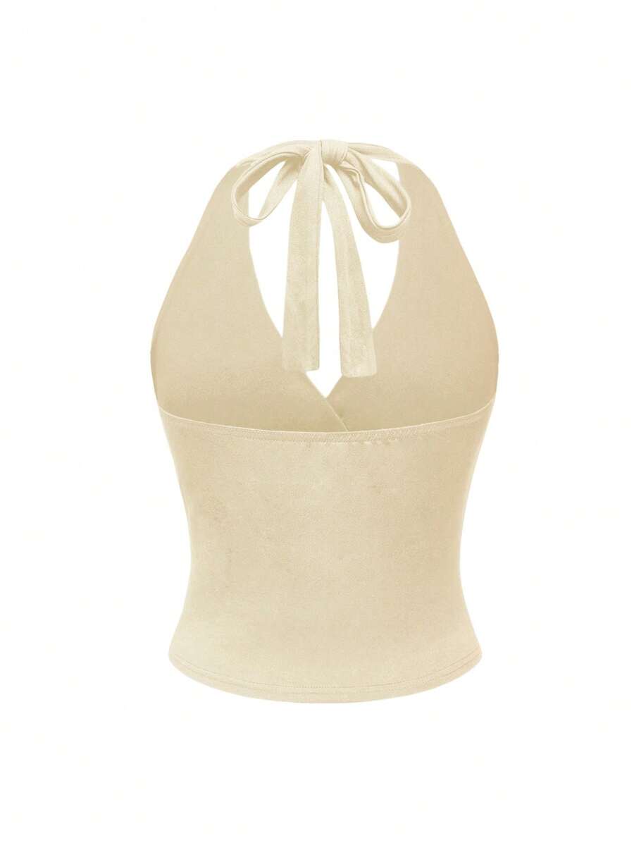 Women's halter crop tank top featuring a backless silhouette and ruched detailing in a slim fit design.