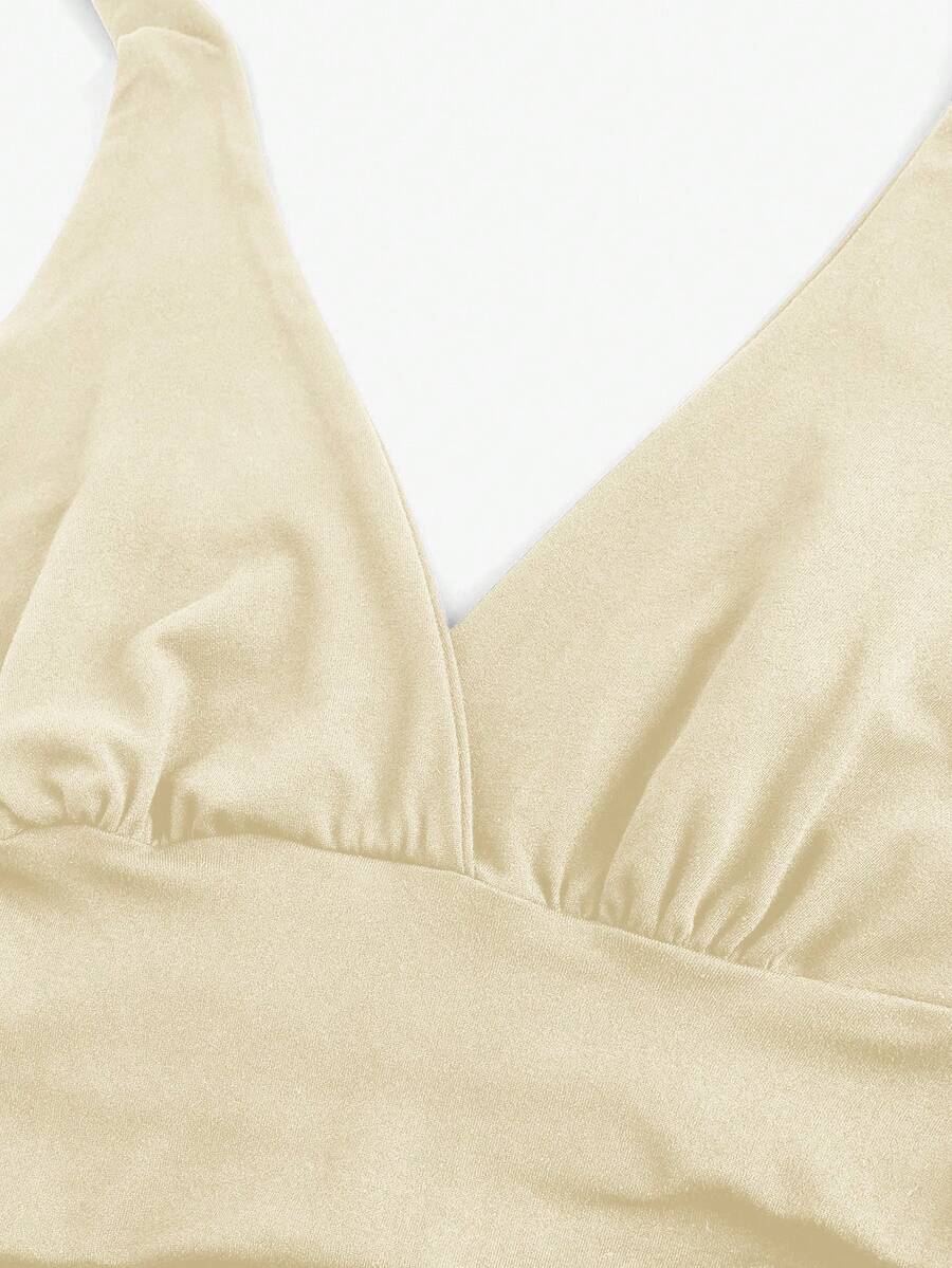 Women's halter crop tank top featuring a backless silhouette and ruched detailing in a slim fit design.