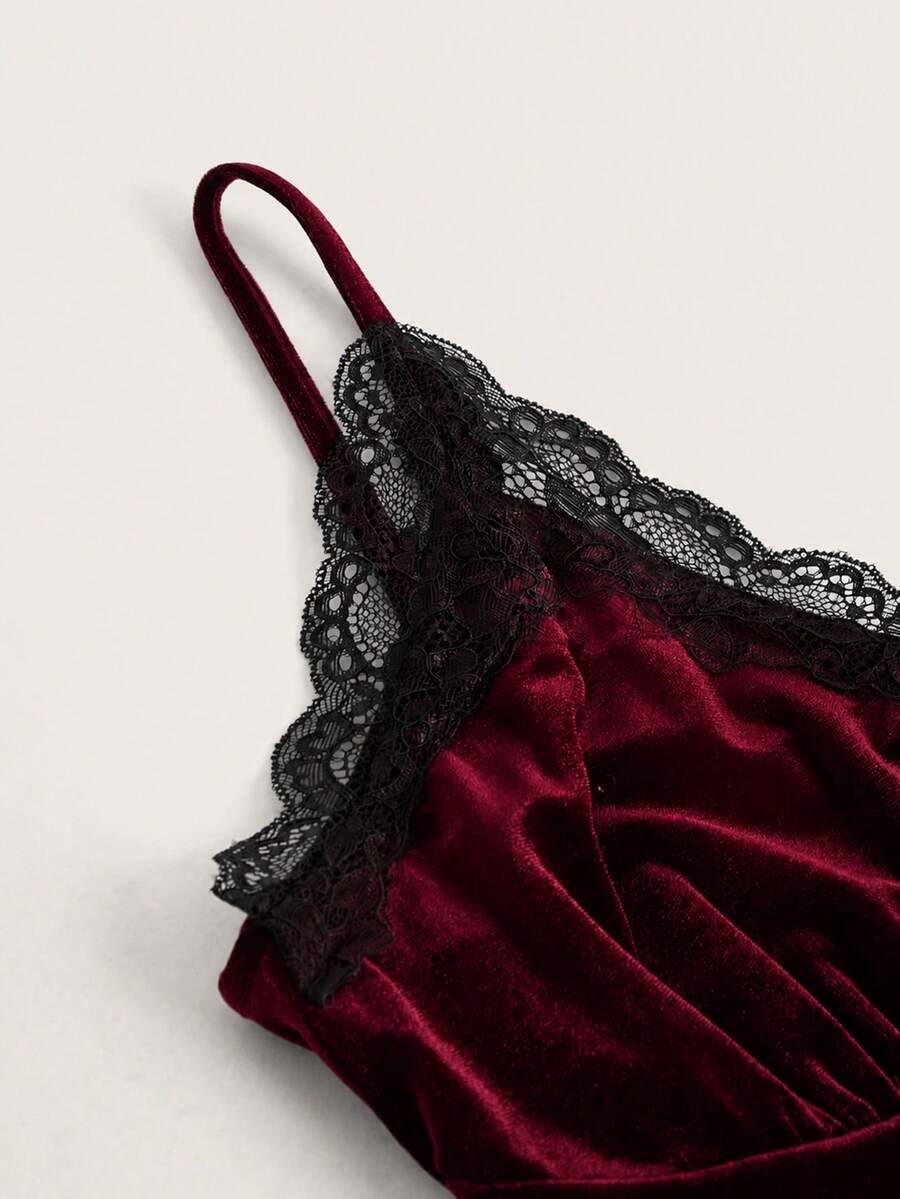 Black gothic velvet crop tank top for women featuring contrast lace trim, bow accent, spaghetti straps, and a metal cross detail.