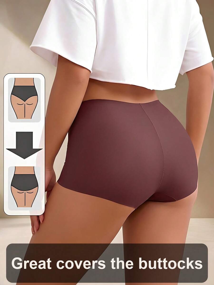 Women's black high stretch shapewear shorts with a mid waist fit and semi-sheer fabric.