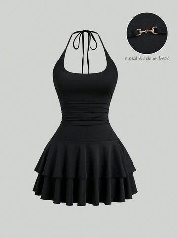 Black sleeveless tiered cami mini dress for women featuring a plain pattern, halter neckline, tie back detail, and layered hem.