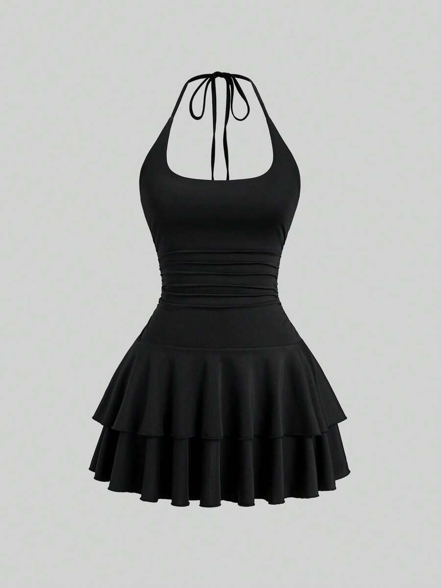 Black sleeveless tiered cami mini dress for women featuring a plain pattern, halter neckline, tie back detail, and layered hem.