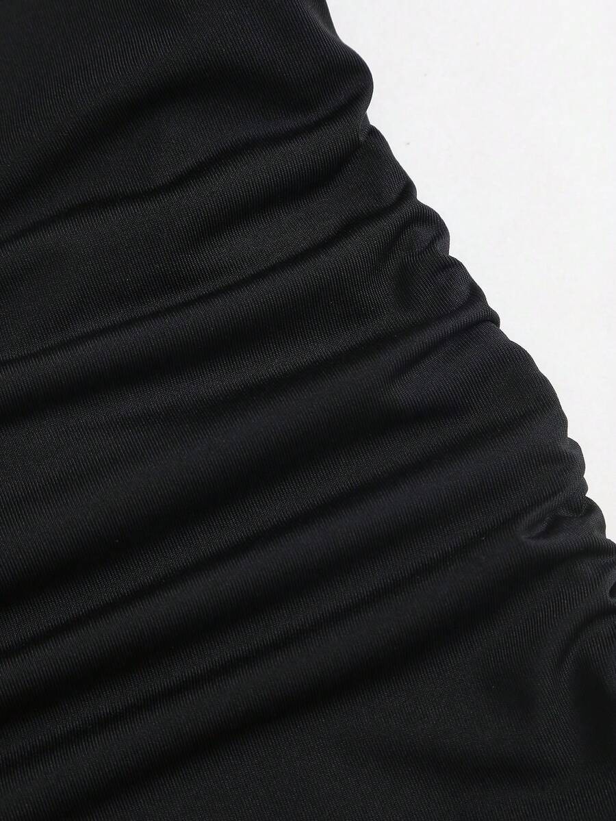 Black sleeveless tiered cami mini dress for women featuring a plain pattern, halter neckline, tie back detail, and layered hem.