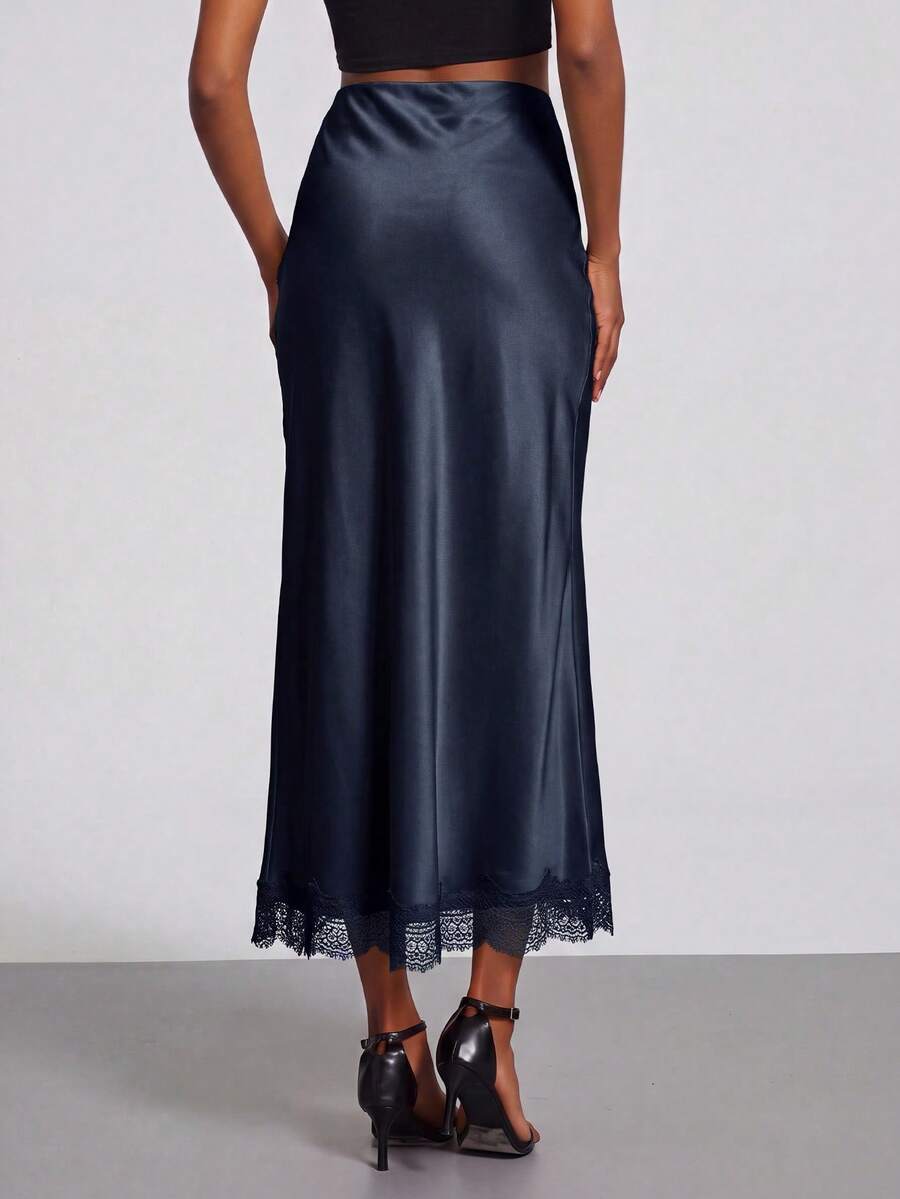 Women's black lace patchwork satin skirt featuring a long bodycon silhouette and natural mid waist design.