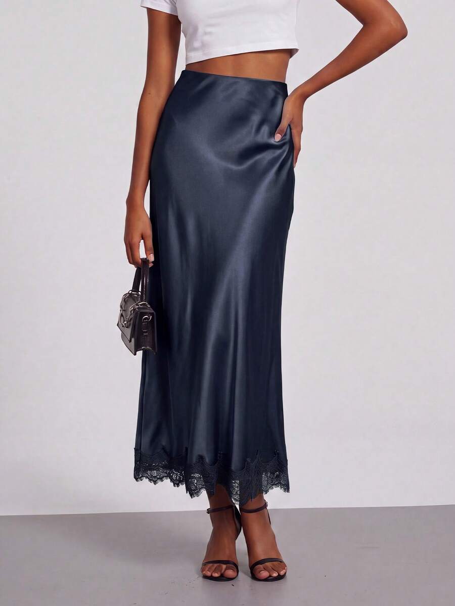Women's black lace patchwork satin skirt featuring a long bodycon silhouette and natural mid waist design.