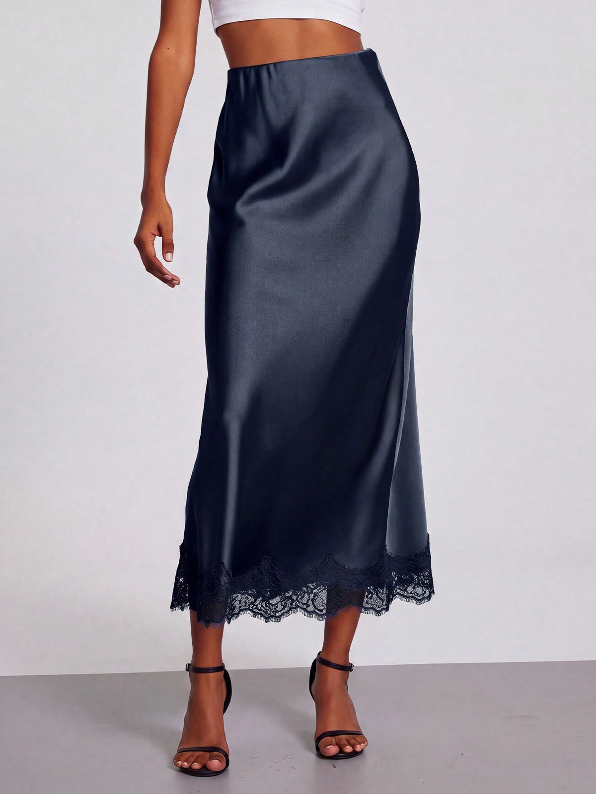 Women's black lace patchwork satin skirt featuring a long bodycon silhouette and natural mid waist design.