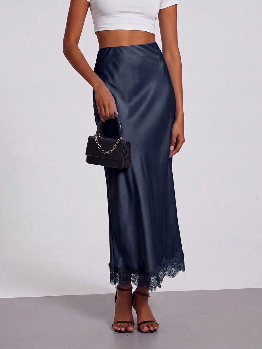 Women's black lace patchwork satin skirt featuring a long bodycon silhouette and natural mid waist design.